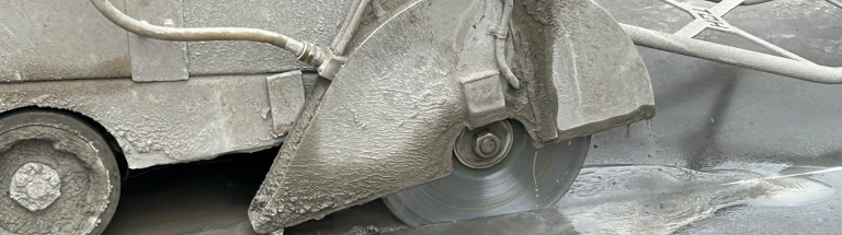 Concrete saw blade cutting through concrete